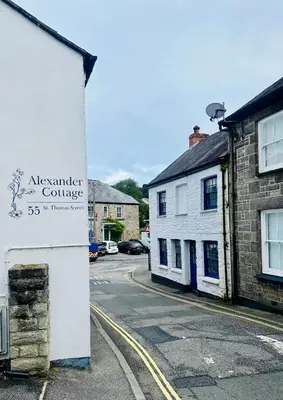a sign on the side of a street with buildings at Alexander cottage in Penryn