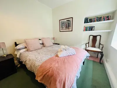 a bedroom with a bed with two towels on it at Alexander cottage in Penryn