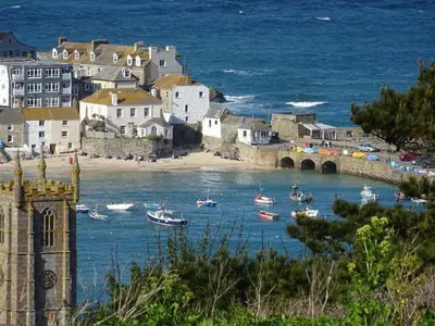 a group of boats in a body of water with a bridge at Cottage By The Sea, Wi-Fi, Pets Accepted in St Ives