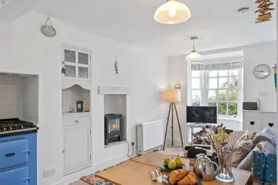 a kitchen with a table with food on it at Cottage By The Sea, Wi-Fi, Pets Accepted in St Ives