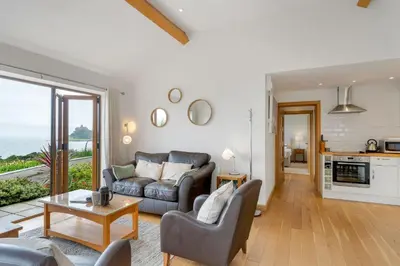 a living room with a couch and a table at Rosemerryn in Marazion