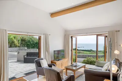 a living room with a view of the ocean at Rosemerryn in Marazion