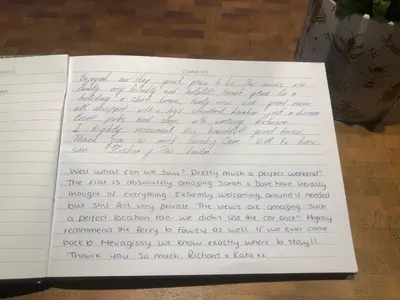 a book with handwriting on it on a table at Mevagissey Boutique Flatlet with sea and countryside views in Mevagissey
