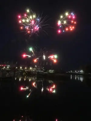 a firework display at night over a body of water at Mevagissey Boutique Flatlet with sea and countryside views in Mevagissey