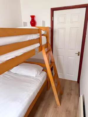 a room with two bunk beds and a door at Riverside home by Camel Trail in Cornwall in Wadebridge
