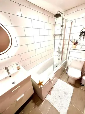 a bathroom with a toilet and a tub and a sink at Riverside home by Camel Trail in Cornwall in Wadebridge