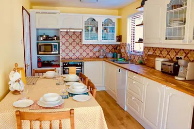a kitchen with a table with plates on it at Riverside home by Camel Trail in Cornwall in Wadebridge
