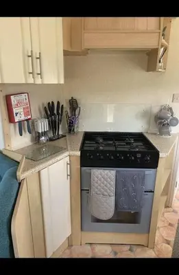 a small kitchen with a stove and a sink at Seven Bays Holiday Home in Padstow