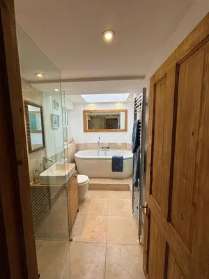 a bathroom with a tub and a toilet and a sink at Mellow Cottage just a short walk to the beach in Perranporth