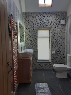 a bathroom with a toilet and a window at The Stables in St Ives in St Ives