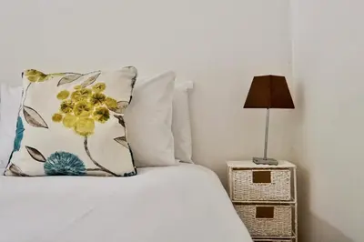 a bed with a pillow and a lamp on a night stand at Special 2 Bedroom Home in White Cross in Saint Columb Major