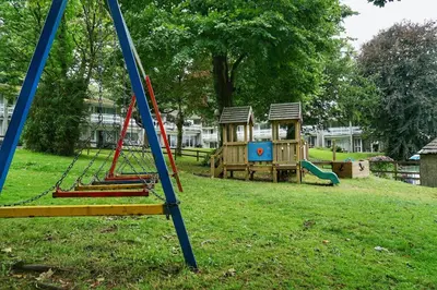a park with a playground with a swing at Special 2 Bedroom Home in White Cross in Saint Columb Major