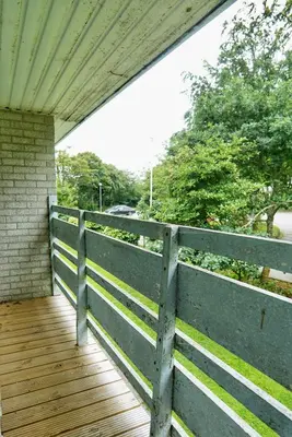 a porch with a fence and a wooden deck at Special 2 Bedroom Home in White Cross in Saint Columb Major