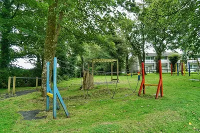 a park with colorful playground equipment in the grass at Special 2 Bedroom Home in White Cross in Saint Columb Major