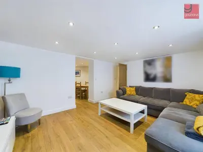 a living room with a couch and a table at TruroFlat in Truro
