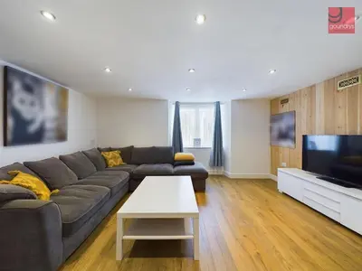 a living room with a couch and a flat screen tv at TruroFlat in Truro