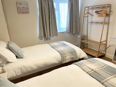 a bedroom with two beds and a window at TruroFlat in Truro