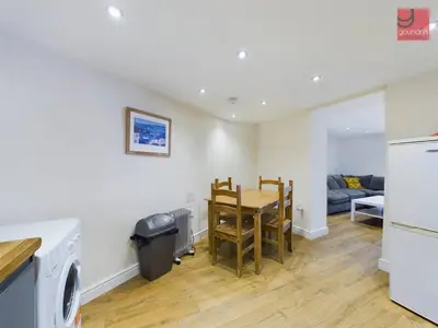 a kitchen and dining room with a table and chairs at TruroFlat in Truro