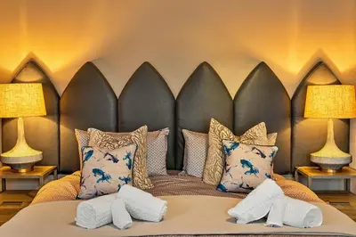 a bedroom with a large bed with pillows at Finest Retreats - Towan House in Newquay