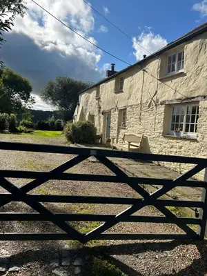 a stone house with a gate in front of it at Meadowside Cottage, Characterful Grade 2 Listed Cottage near to Wadebridge and Padstow in Wadebridge