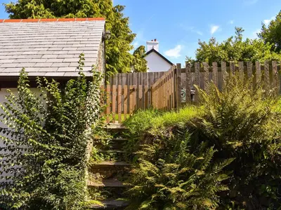 a wooden fence in front of a house at Tarow Cottage in Morval