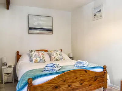 a bedroom with a bed with towels on it at Tarow Cottage in Morval