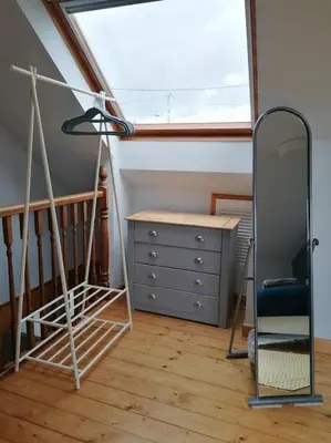 a dressing room with a mirror and a dresser at The Little House, Wadebridge, Cornwall in Wadebridge