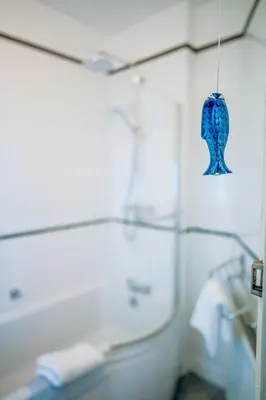 a blue glass ornament hanging from a wall at Marazion Beach Town House with Private Parking in Marazion
