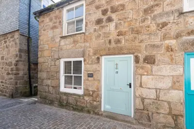 a stone building with a blue door and windows at Old Arch Cottage, The Digey - 100m From Town & Beach - Free WiFi - 2 Pets Allowed in St Ives