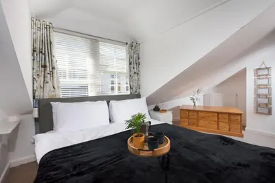 a bedroom with a large bed and a window at Old Arch Cottage, The Digey - 100m From Town & Beach - Free WiFi - 2 Pets Allowed in St Ives