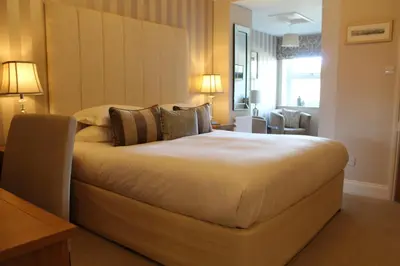 a bedroom with a large bed in a room at Camelot Guest House in Falmouth
