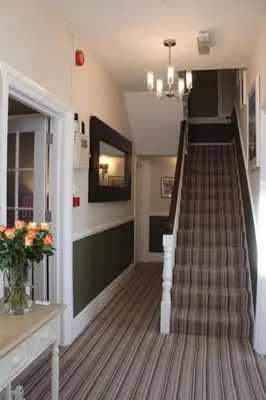 a staircase in a home with a stair case at Camelot Guest House in Falmouth