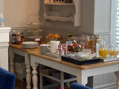 a table with food and drinks on top of it at Camelot Guest House in Falmouth