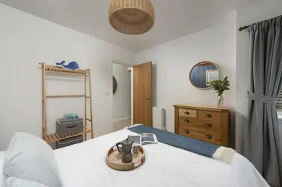 a bedroom with a bed with a wooden bowl on it at Lobbs Cottage, St Mawgan - Free WiFi - Pet Friendly - Free Parking in Saint Mawgan