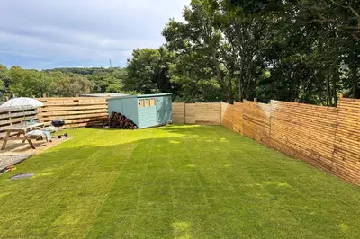 a small yard with a fence and a shed at Lobbs Cottage, St Mawgan - Free WiFi - Pet Friendly - Free Parking in Saint Mawgan