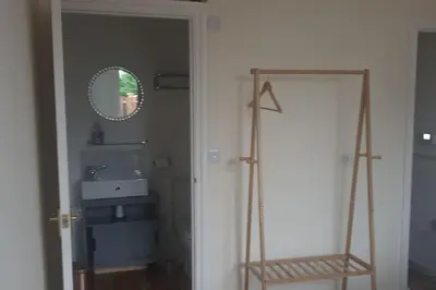 a bathroom with a sink and a mirror and a ladder at New modern self contained Cottage in Delabole