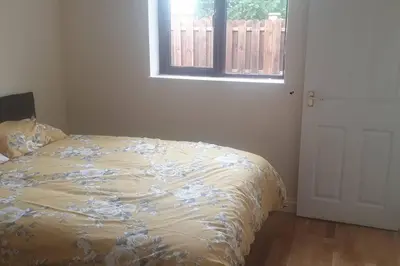 a bedroom with a bed and a window and a door at New modern self contained Cottage in Delabole