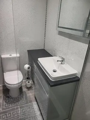 a bathroom with a white toilet and a sink at The Cosy Nook in Redruth