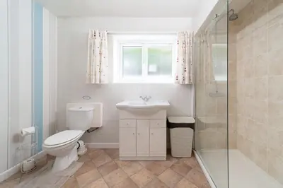 a bathroom with a toilet and a sink and a shower at Seagulls Cottage Cornwall in Saint Mawes
