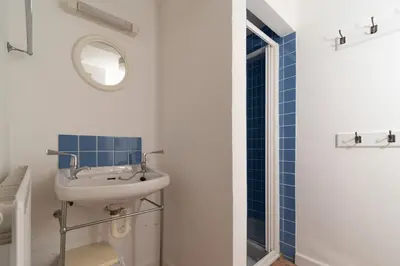 a bathroom with a sink and a mirror at Seagulls Cottage Cornwall in Saint Mawes