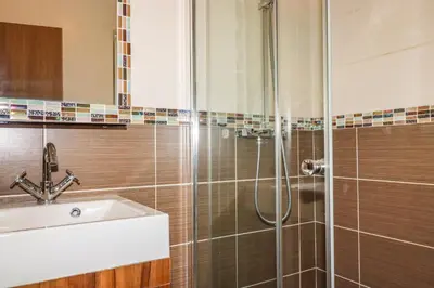 a bathroom with a shower and a sink at Hideaway Lodge in Tintagel