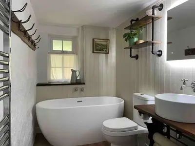 a bathroom with a tub and a toilet and a sink at The Anvil, 2 bed cottage, in the heart of Cornwall in Gwennap