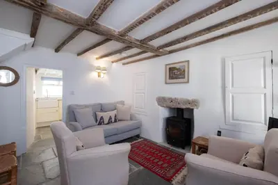 a living room with two couches and a fireplace at Mobray, Port Isaac Bay Holidays in Port Isaac