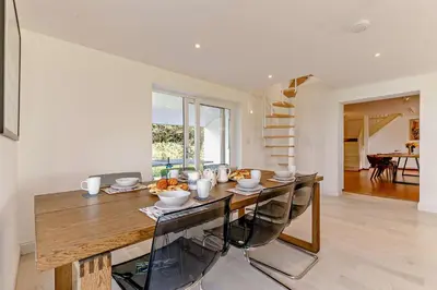 a dining room with a wooden table and chairs at 5 Bed in St. Merryn oc-t27899 in St Merryn