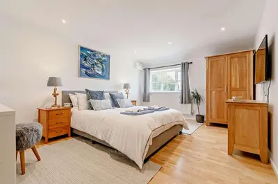 a bedroom with a bed and a dresser and a window at 5 Bed in St. Merryn oc-t27899 in St Merryn