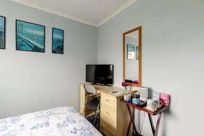 a bedroom with a bed and a desk with a mirror at Bed & Breakfast Only - not 24 hour lodging - Truro, Cornwall - free parking in Truro