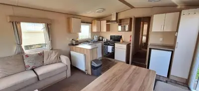 a small kitchen and living room in a caravan at NB166 - Porth Bay Hideaway in Porth