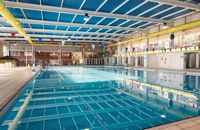 a large swimming pool filled with blue water at NB166 - Porth Bay Hideaway in Porth