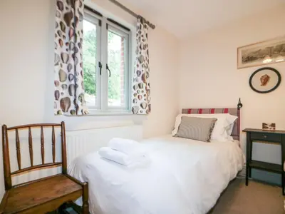 a bedroom with a bed and a window at Pirata in St Austell