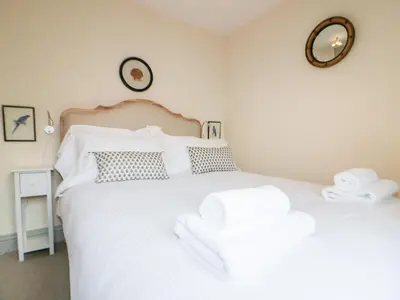 a bedroom with two beds and a mirror on the wall at Pirata in St Austell
